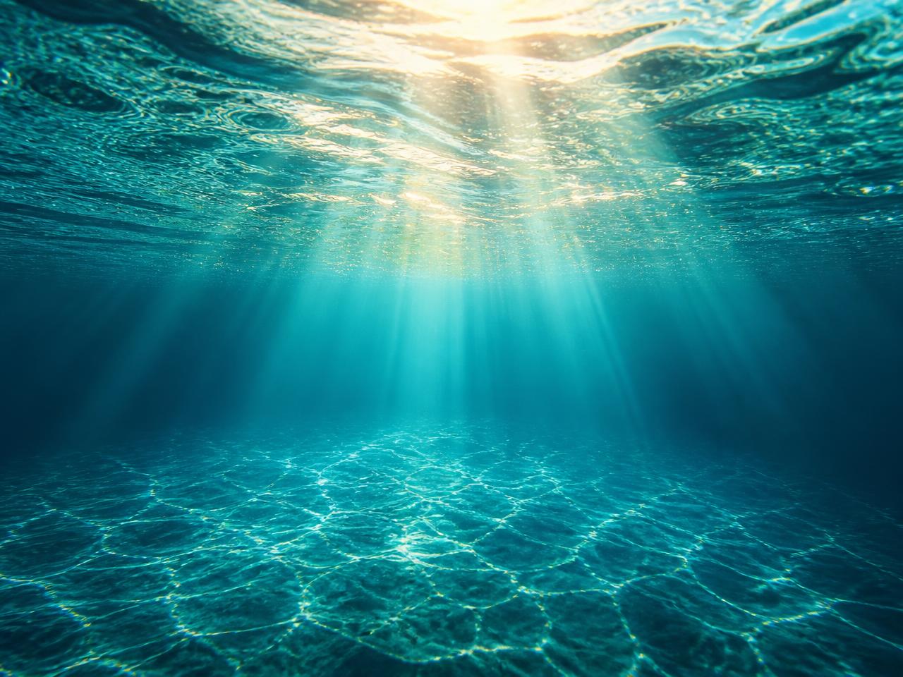 Sunlight breaking through clear turquoise ocean water